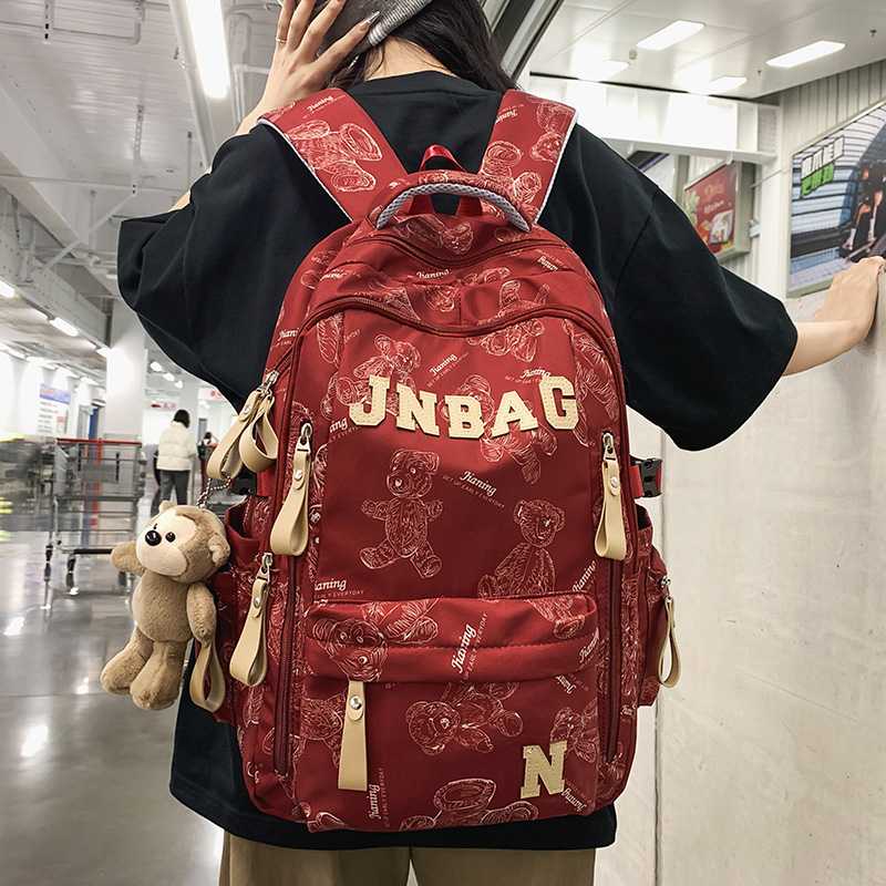 减负书包男生高中生大容量双肩包初中女生印花大学生休闲旅行背包