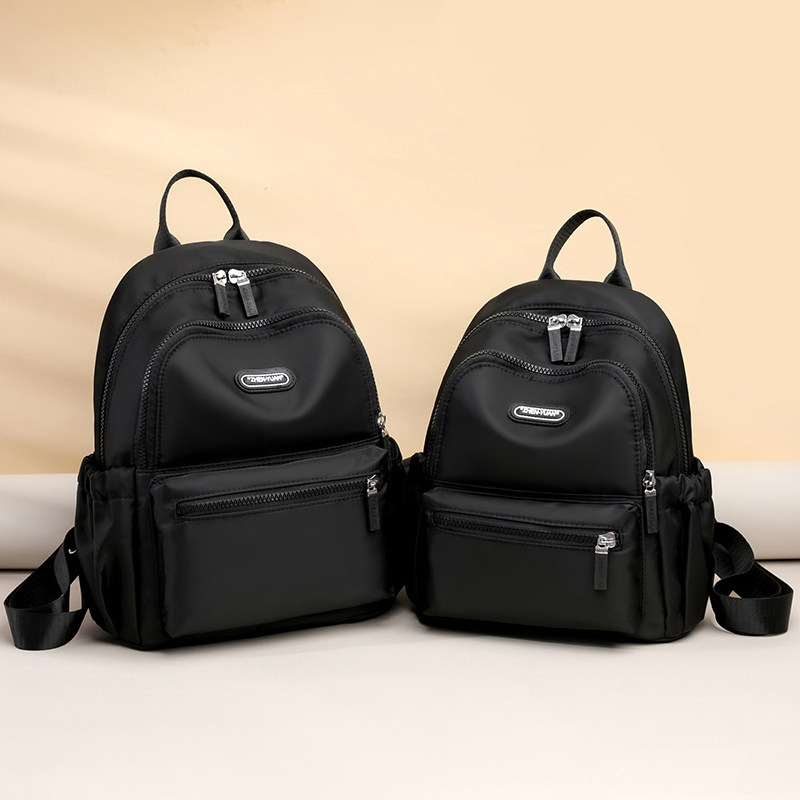 牛津布双肩包女2026新款时尚百搭轻便大容量防水帆布夏季旅行背包