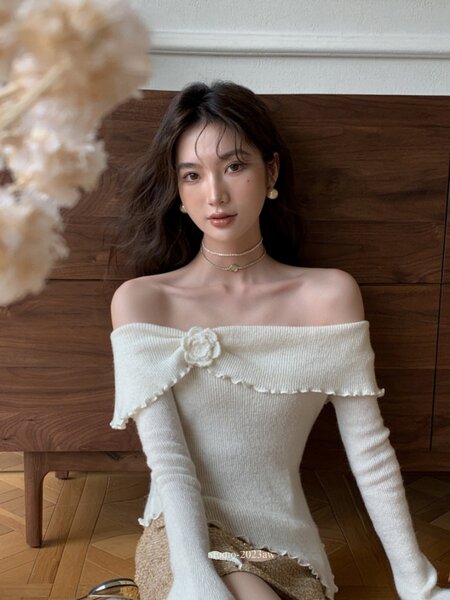 White off-shoulder knit sweater dress worn by a model