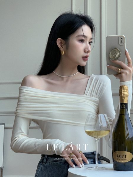 Woman wearing a white off-shoulder long-sleeve top