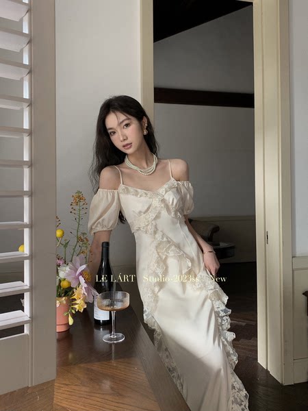 Cream satin lace off-shoulder dress worn by a model