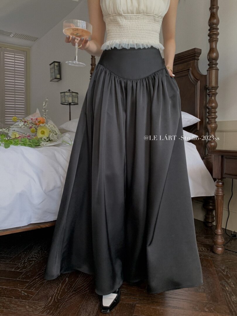 Black flowy maxi skirt worn by a model indoors