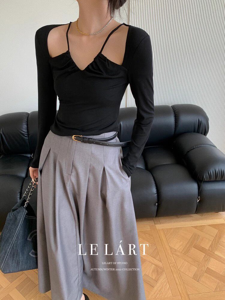 Model wearing a black long-sleeve top with gray wide-leg pants