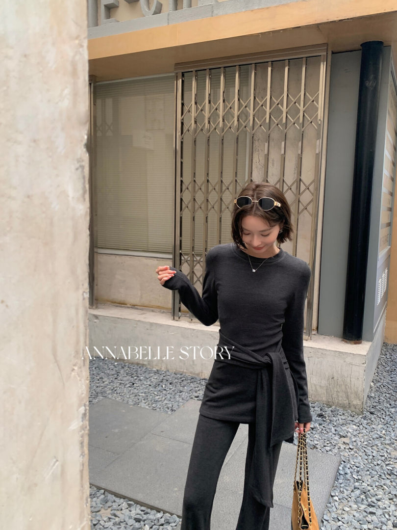 Black long-sleeve fitted outfit worn by a model outdoors