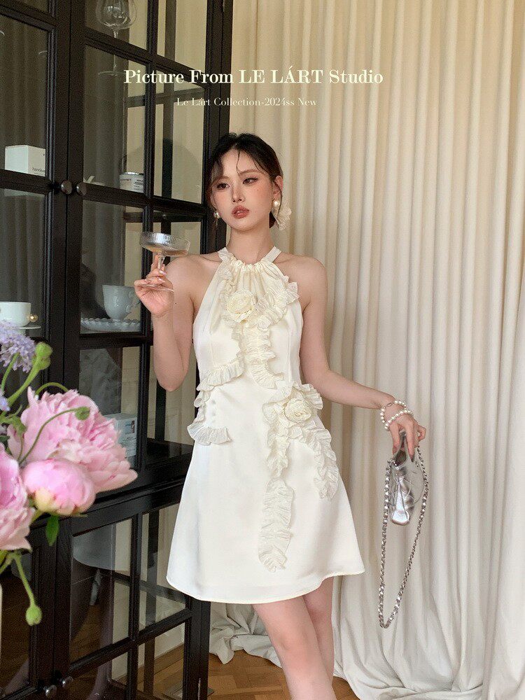 White halter mini dress with ruffle floral details worn by a model