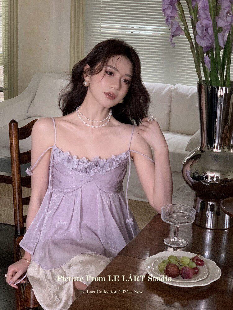 Woman wearing a lavender spaghetti-strap dress indoors