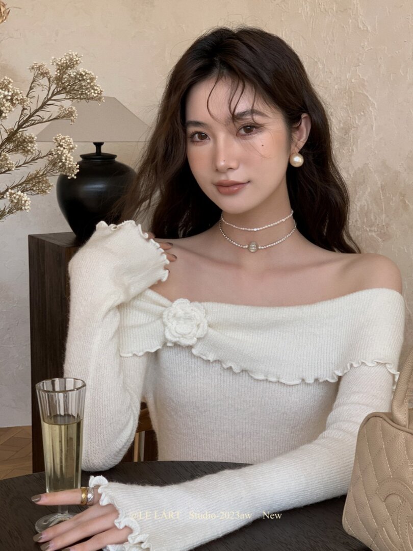 White off-shoulder knit top worn by a model