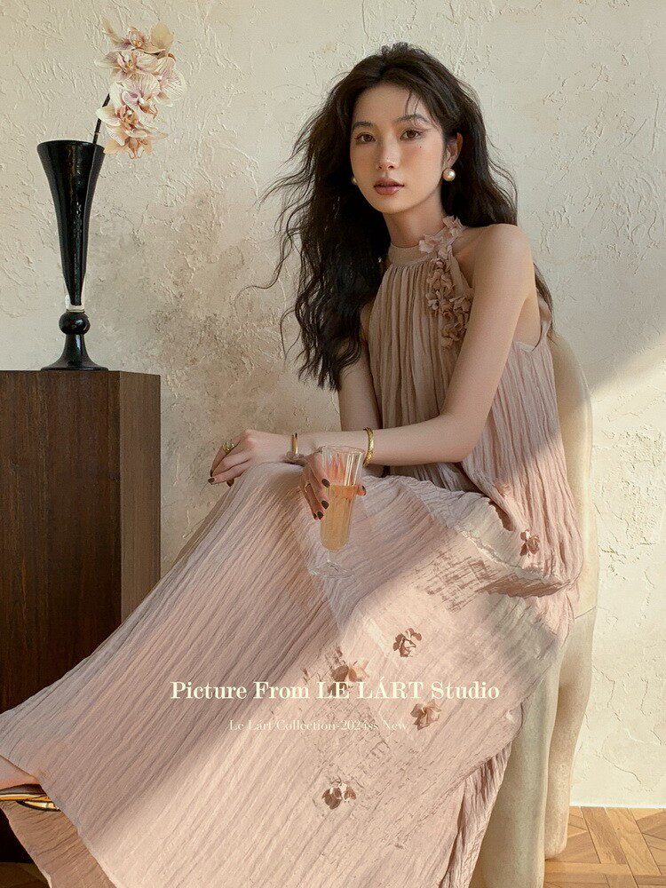 Light pink pleated sleeveless dress worn by a model