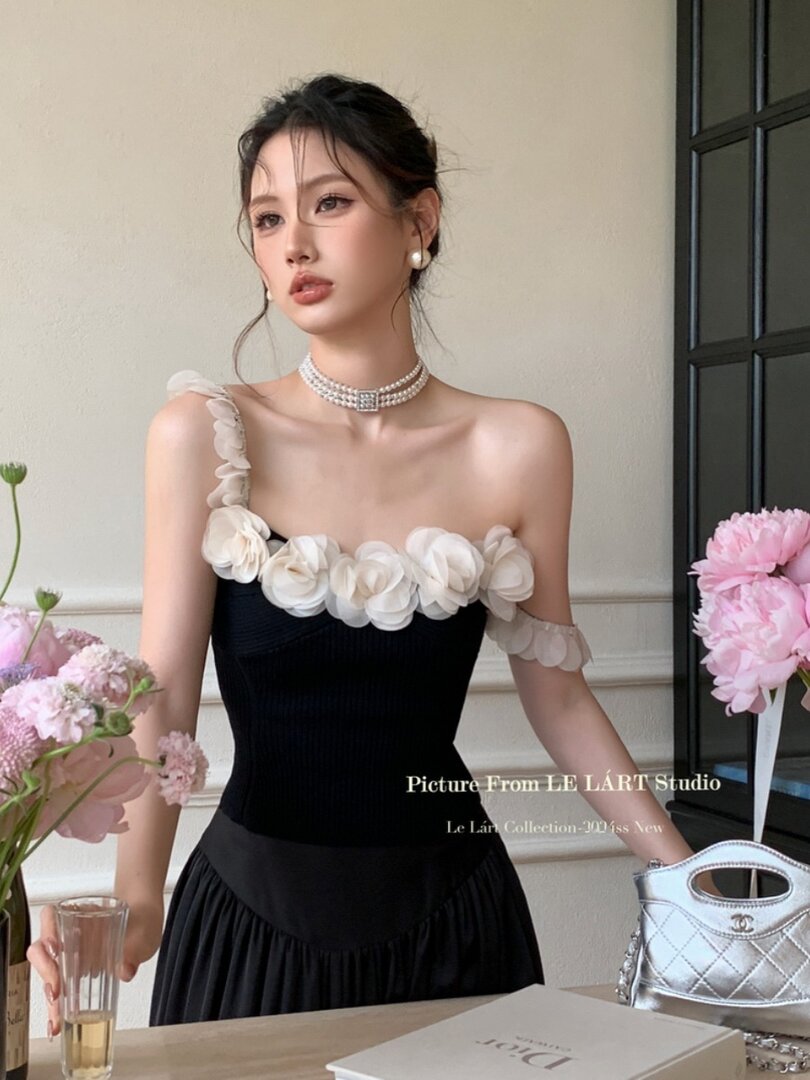 Black elegant floral-embellished dress worn by a model