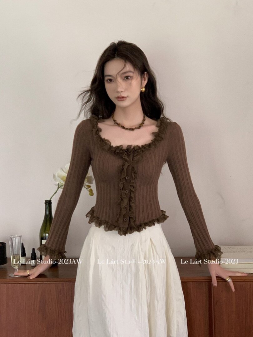 Woman wearing a brown ribbed ruffle-trim long-sleeve top
