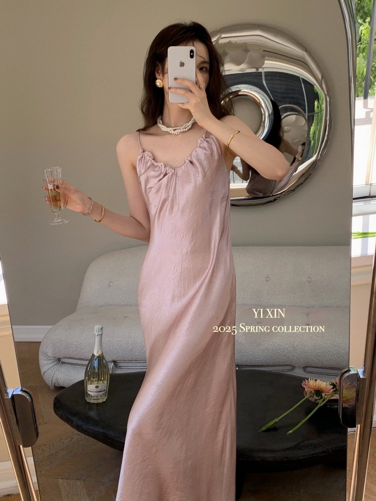 Pink satin slip dress worn by a model in a mirror selfie