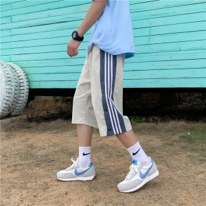    夏季新款排扣开叉七分裤男宽松运动条纹裤子图片