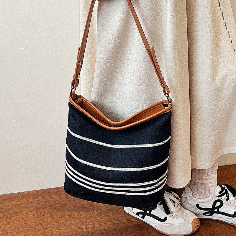 水桶包百搭休闲新款帆布包通勤2026单肩大容量大学生斜挎包包女式
