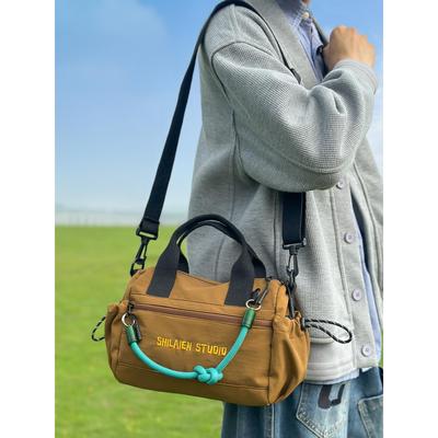 尼龙布包女大容量2025新款秋冬休闲斜挎户外运动风男士手提通勤包