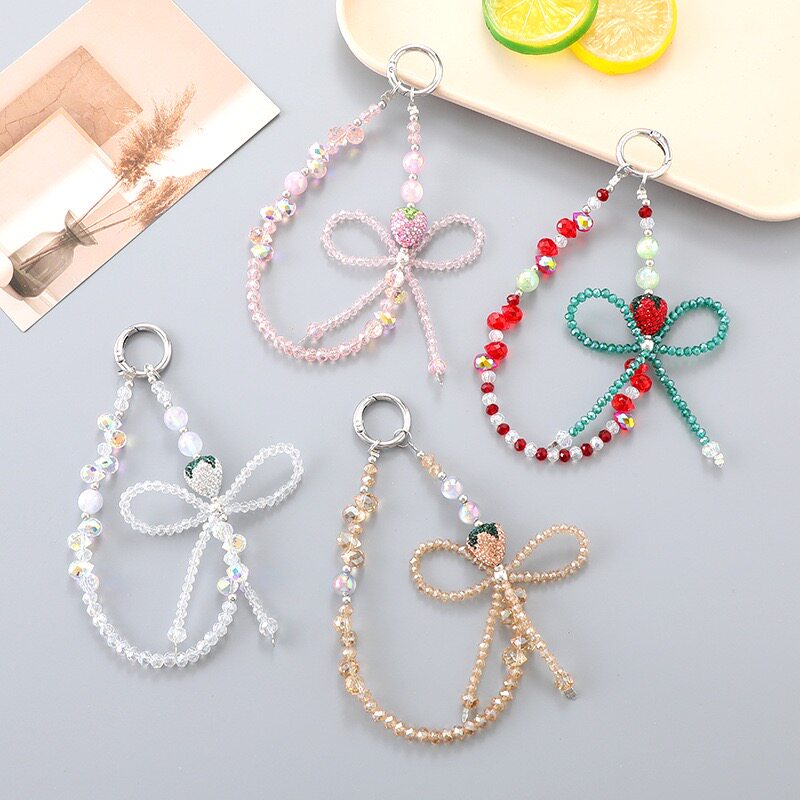 春日新款泪珠水晶手工串珠蝴蝶结闪闪水钻草莓百搭包包手机壳挂件