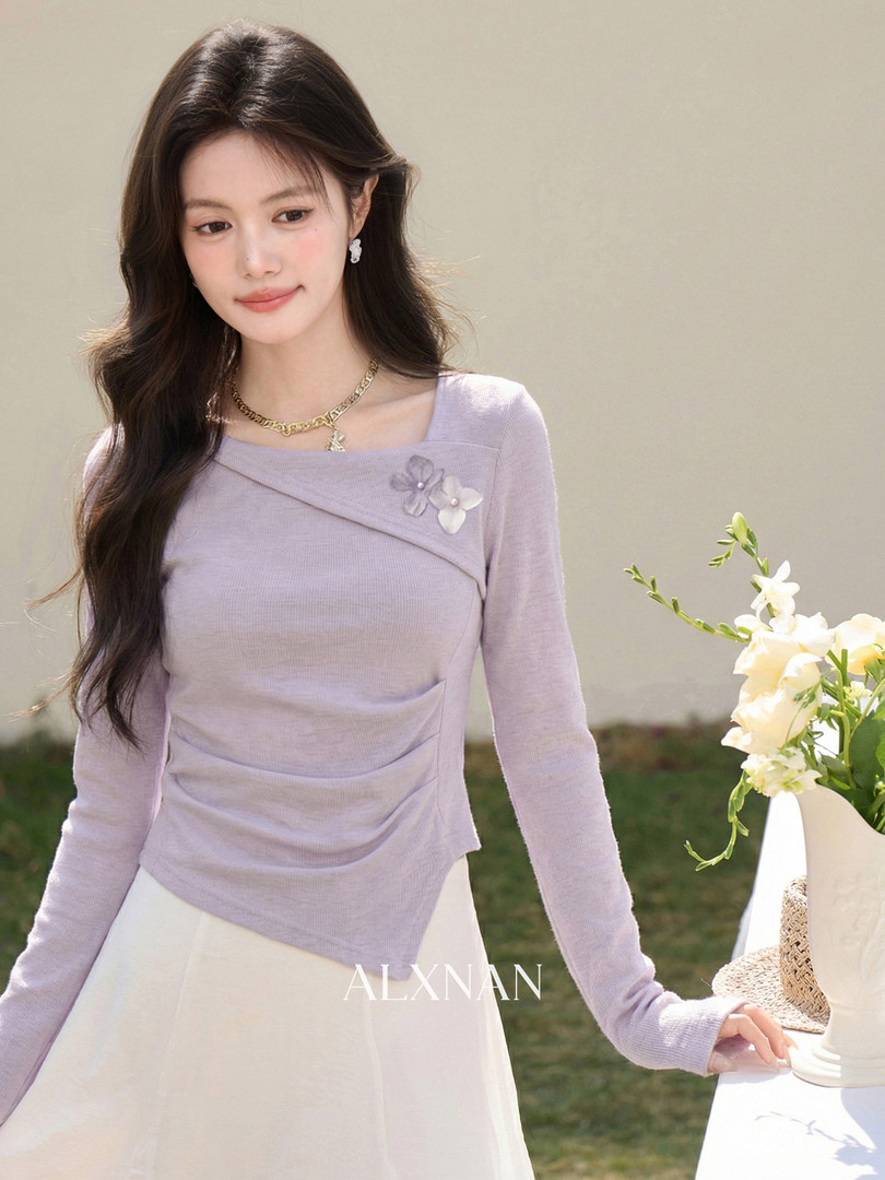 Lavender long-sleeve fitted top worn by a model with floral embellishment