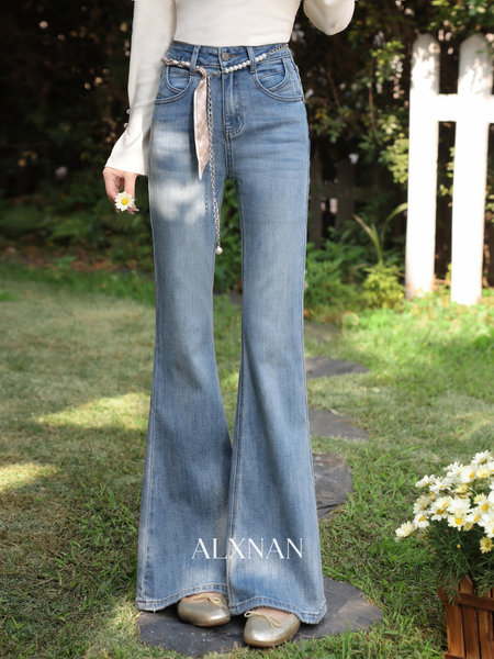 Light blue high-waisted flared jeans worn by a model outdoors
