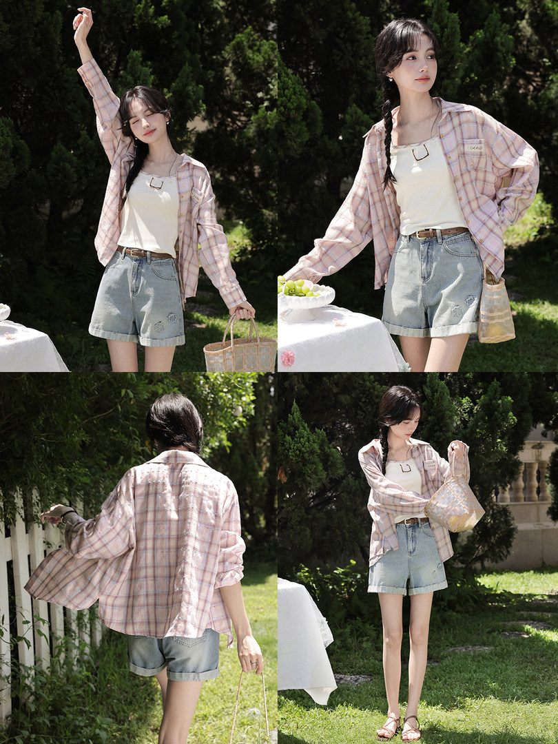 Model wearing a pink plaid shirt over a white tank top with denim shorts outdoors