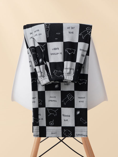 Black and white patterned loungewear pants displayed on a stand