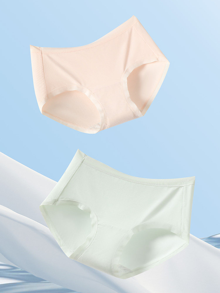 Two pairs of seamless underwear in nude and white on a blue background