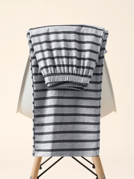 Gray and black striped pants folded on a chair