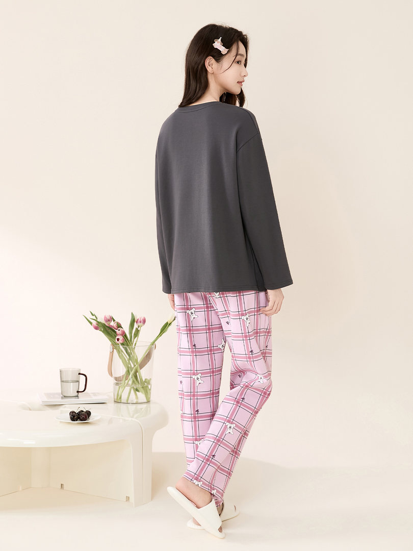 Model wearing a dark gray long-sleeve pajama top with pink plaid lounge pants