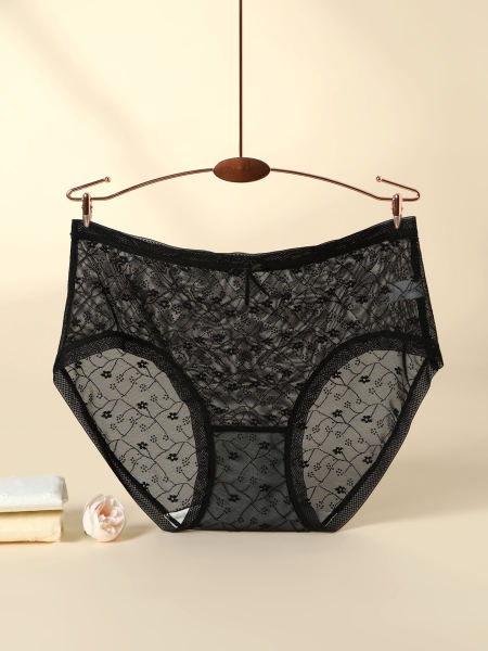 Black sheer lace underwear shorts hanging on a hanger
