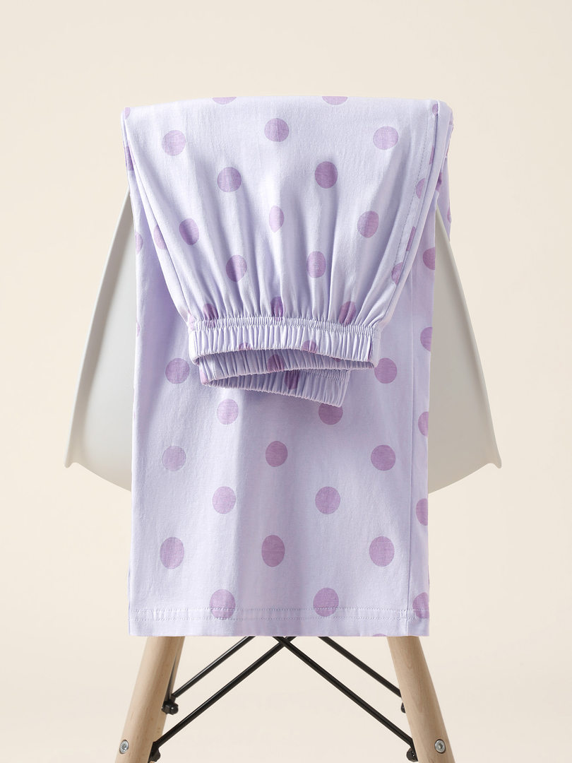 Lavender polka dot elastic-waist clothing item displayed on a chair