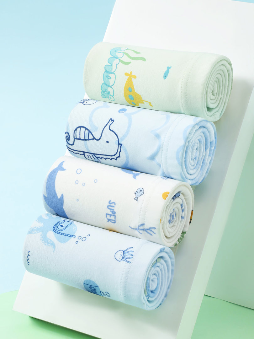 Rolled pastel baby fabric blankets with animal prints