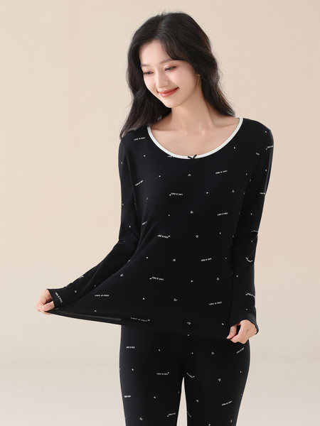 Black long-sleeve loungewear set with small heart and text print worn by a model