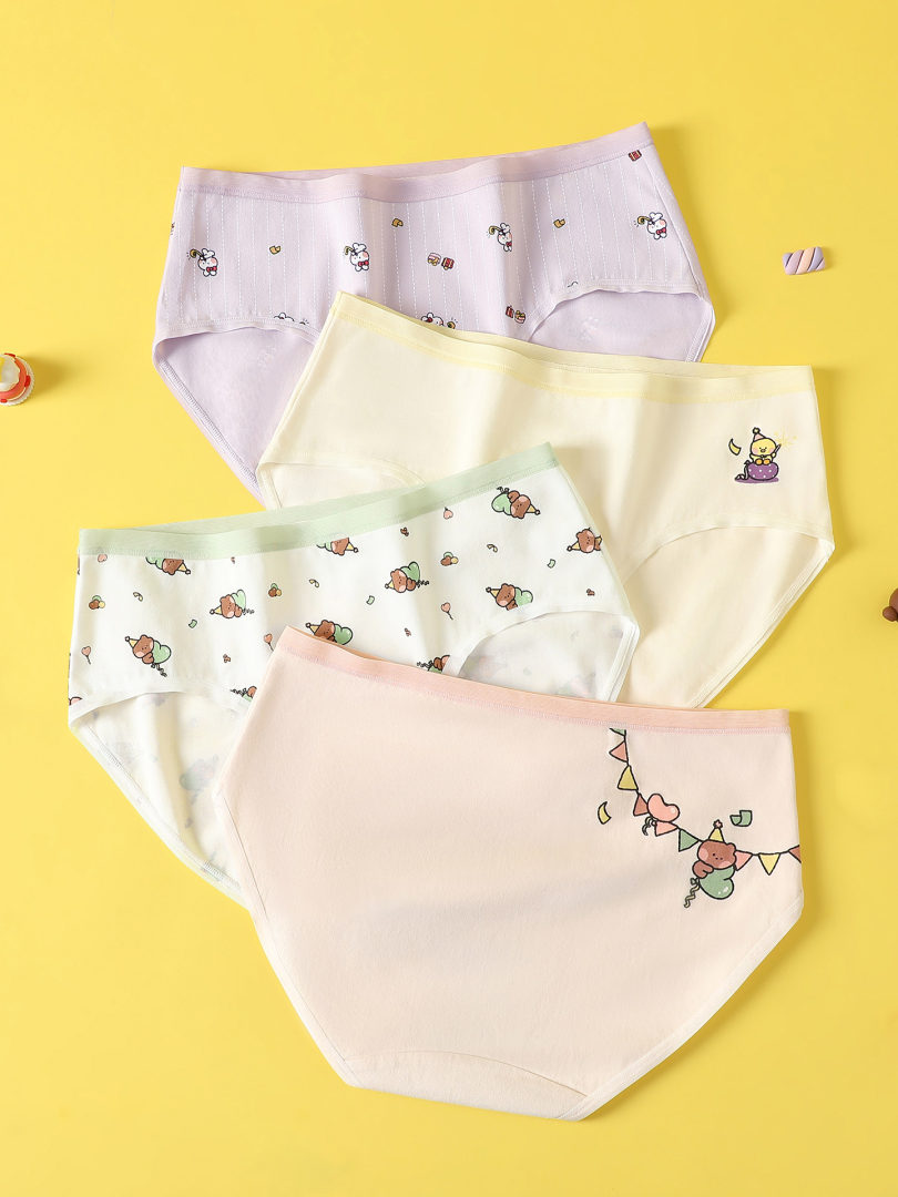 Flat lay of pastel printed women's underwear briefs on a yellow background