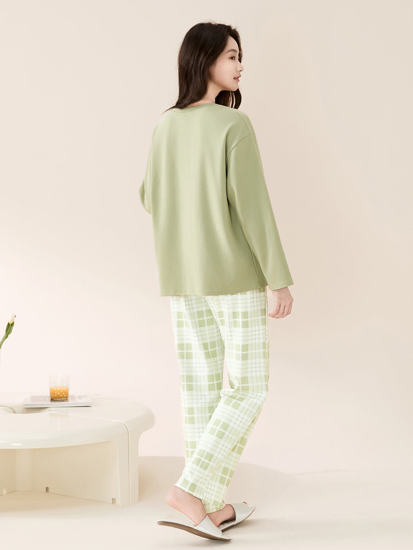 Model wearing a light green loungewear set with plaid pants