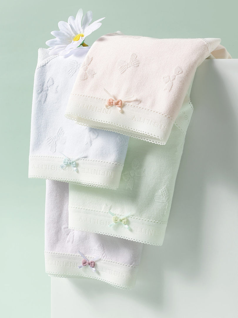 Pastel embroidered towels or cloths draped on a stand