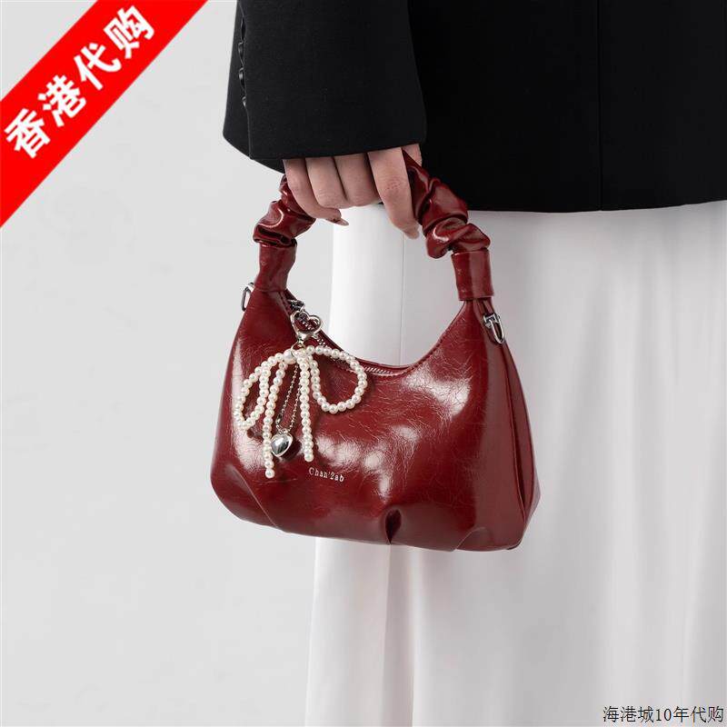 包包女2025新款超火爆款红色手提褶皱水饺包高级感轻奢小众斜挎包