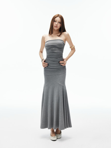 Model wearing a gray strapless ruched maxi dress