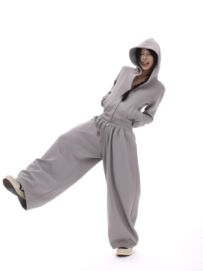 Gray hooded zip-up sweatshirt and wide-leg pants set worn by a model
