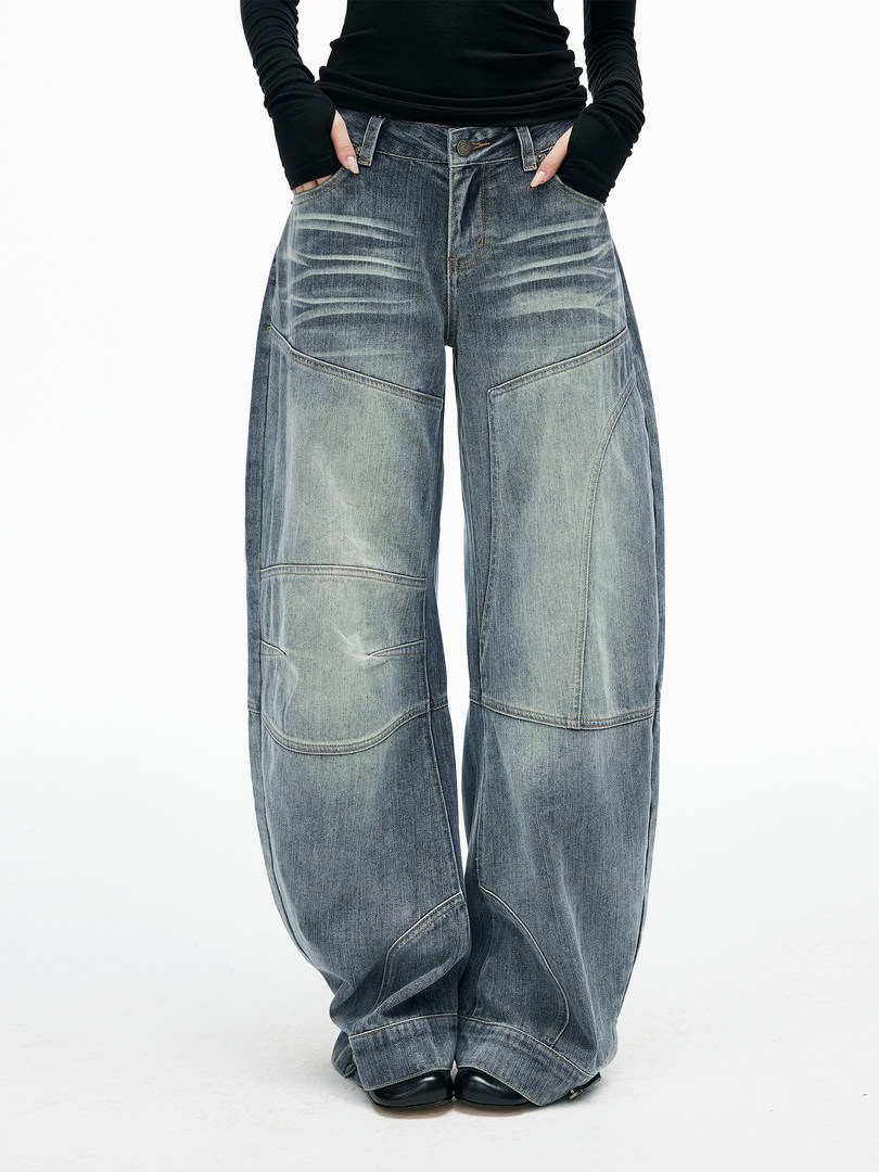 Model wearing oversized washed denim jeans with a wide-leg fit