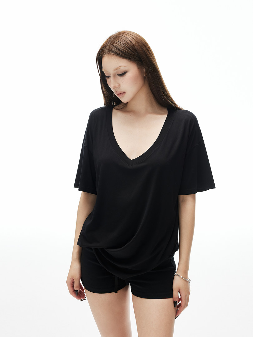 Black V-neck oversized short-sleeve top with black shorts on a model