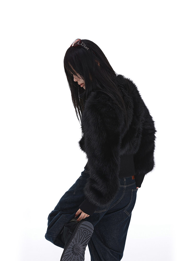 Model wearing a black fur jacket and dark jeans