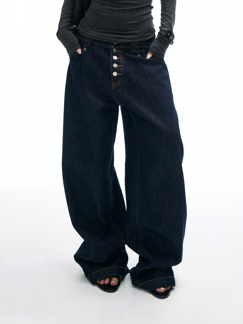 Dark wide-leg denim jeans worn by a model