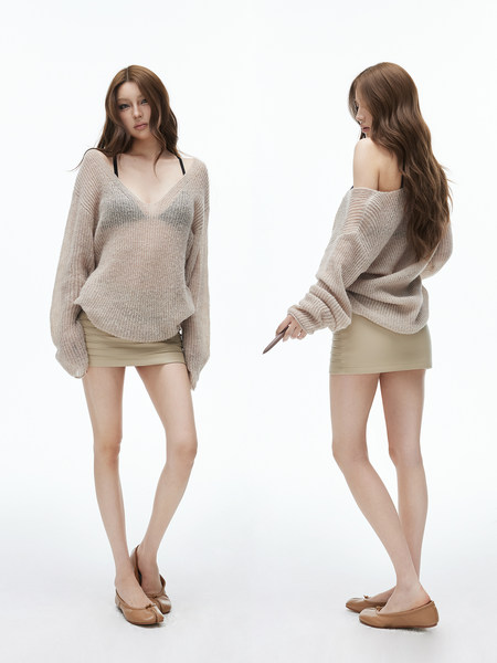 Model wearing a sheer beige knit sweater with a beige mini skirt and flats