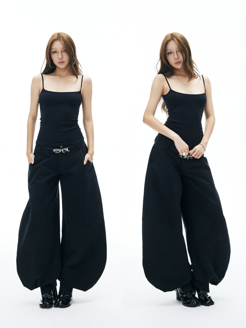 Model wearing a black fitted tank top and oversized wide-leg pants
