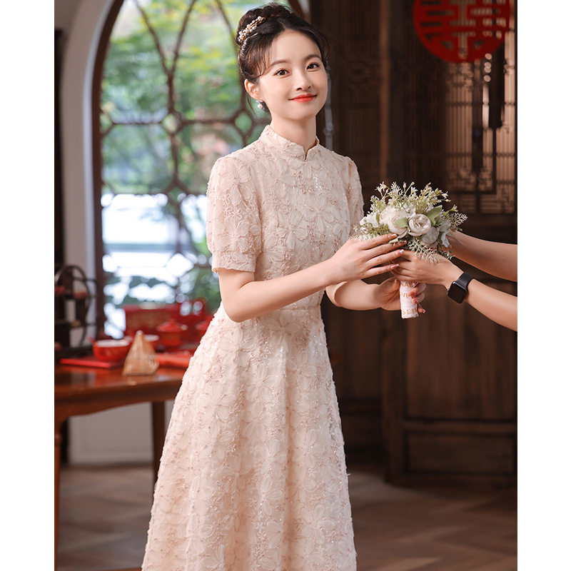 粉色订婚晚礼服女2026新款感旗袍连衣裙轻奢小众高端花朵中式女装