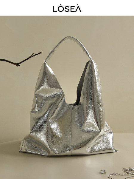 Silver metallic handbag on a neutral background