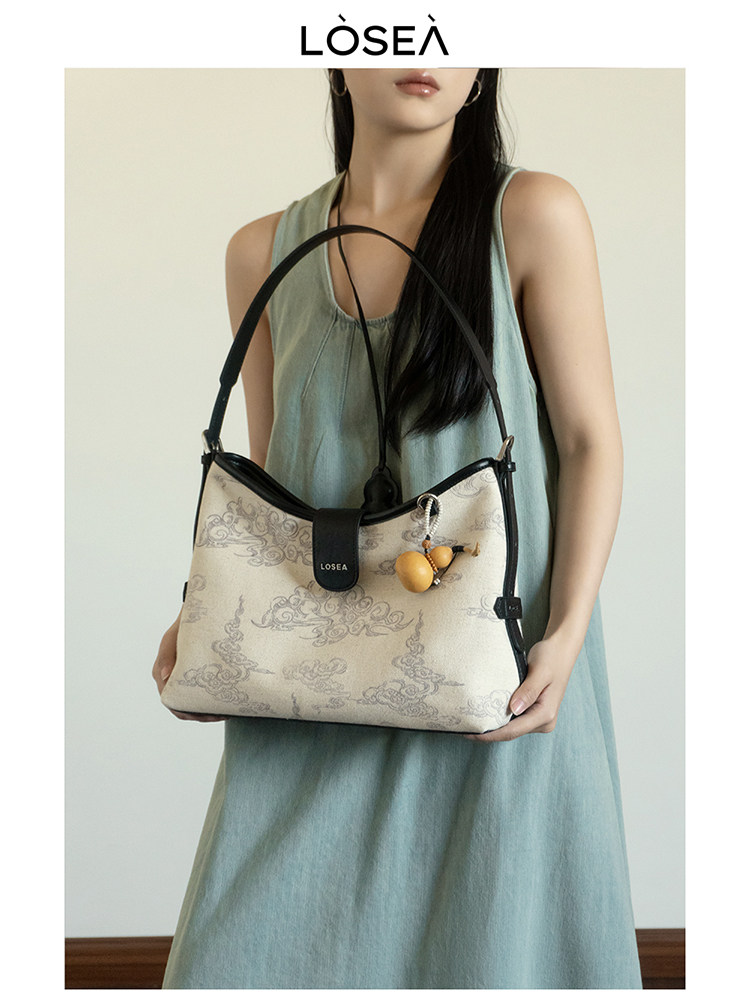 Patterned shoulder handbag worn by a model