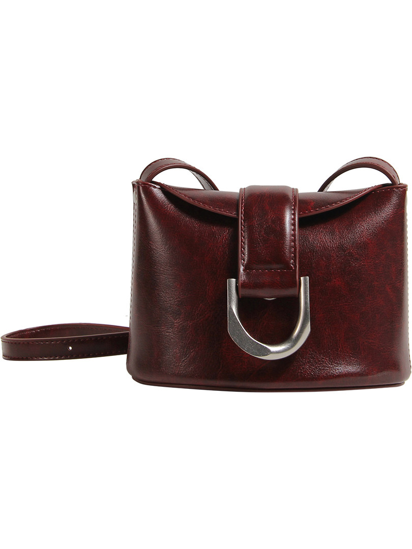 Burgundy leather handbag with a metal buckle on a white background