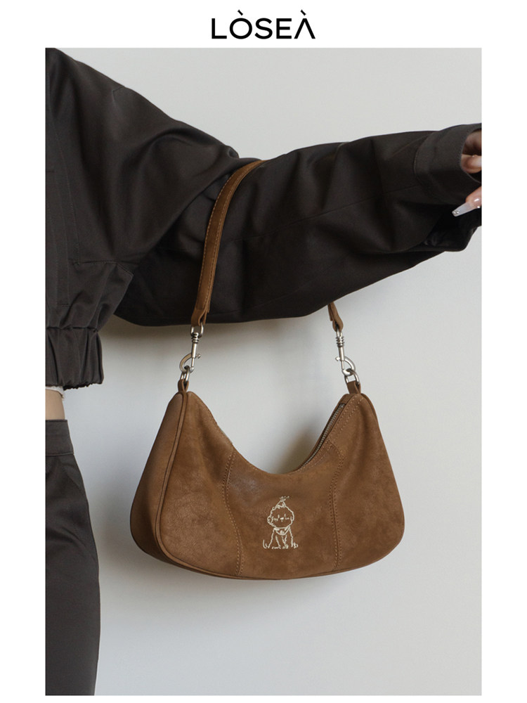 Brown shoulder handbag worn with a black outfit