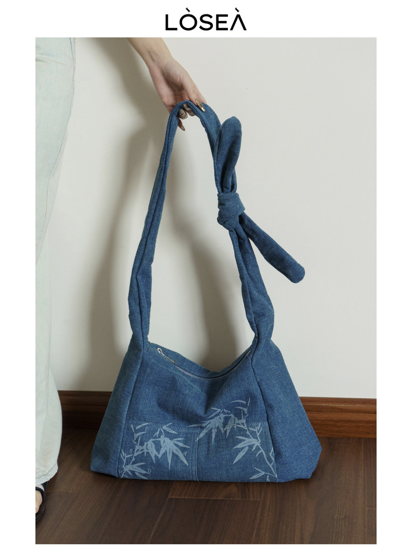 Blue denim shoulder handbag with printed bamboo pattern