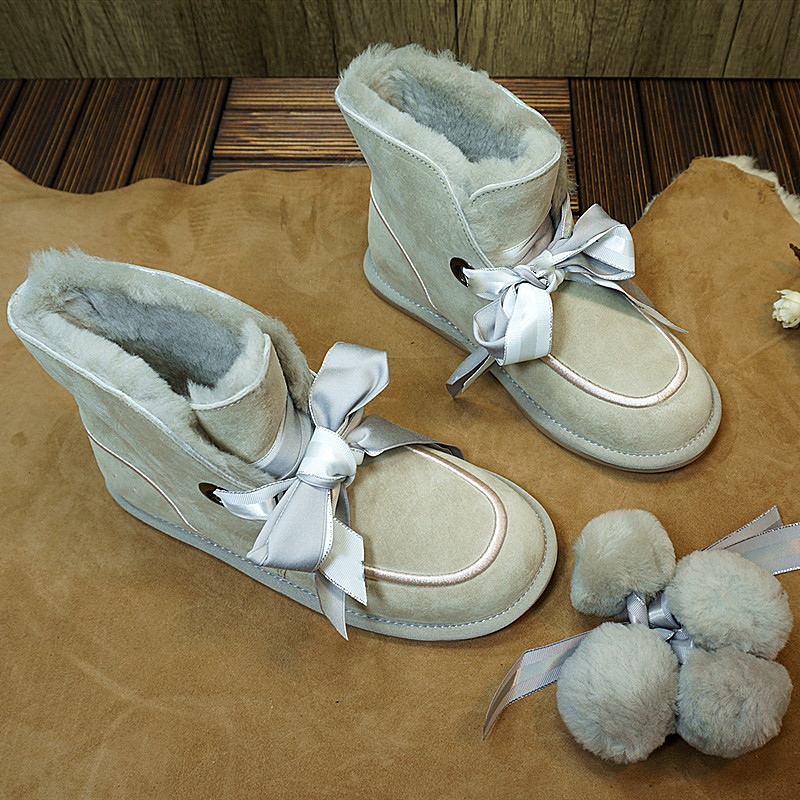 冬季新款丝带毛球真皮一体短筒靴