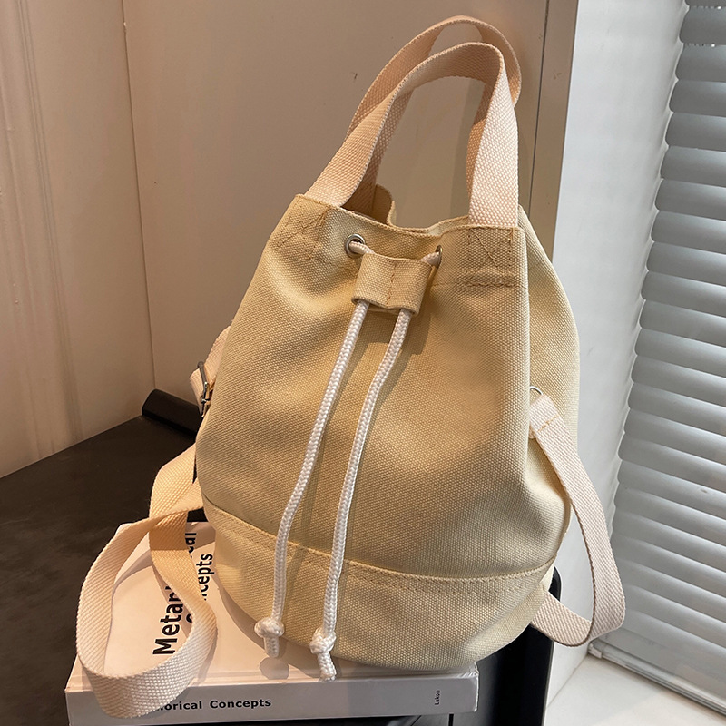 韩版简约帆布包包女2025时尚休闲手提水桶包学生百搭单肩斜挎包